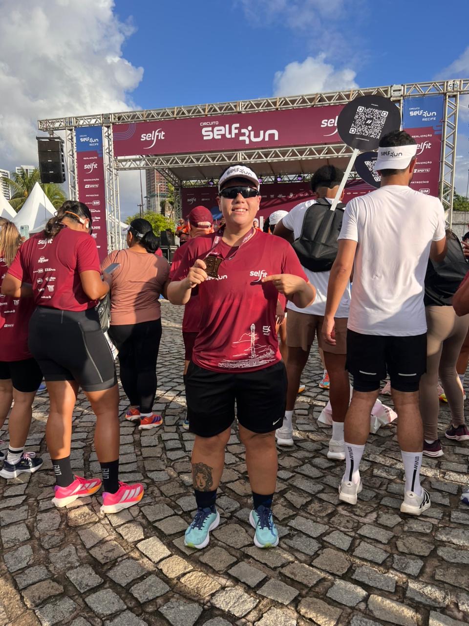 Dayane depois, mostrando sua medalha em um evento de corrida